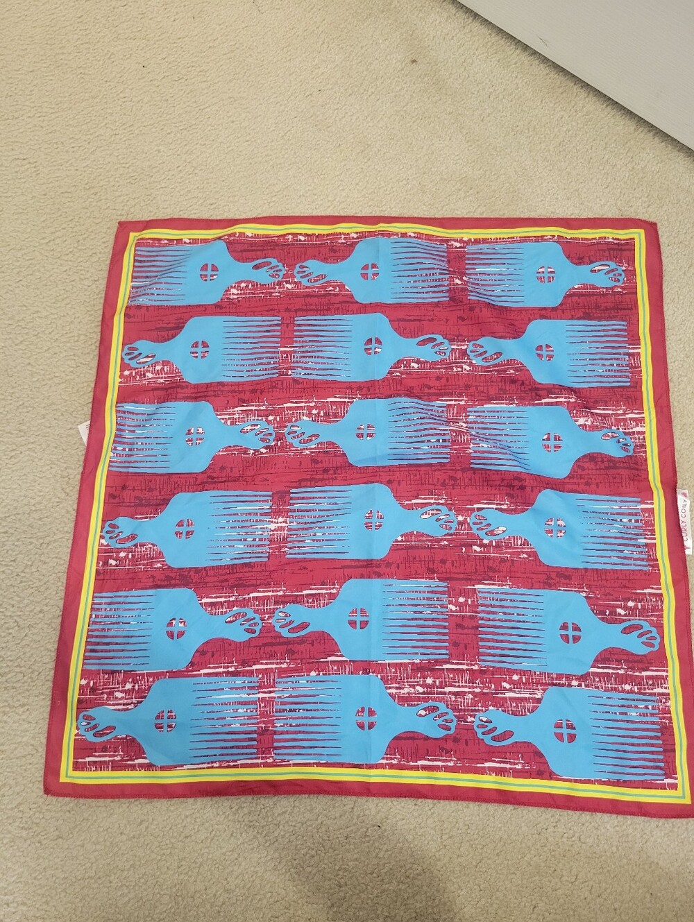 Lush Red Throw with Blue Graphic Pattern and Yellow Trim